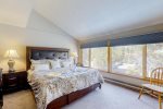 Elongated windows provide nice forested views from master bedroom